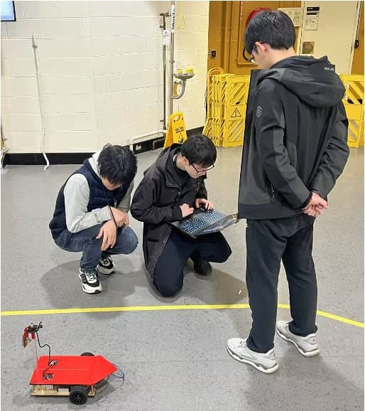 Team members preparing the autonomous racing robot