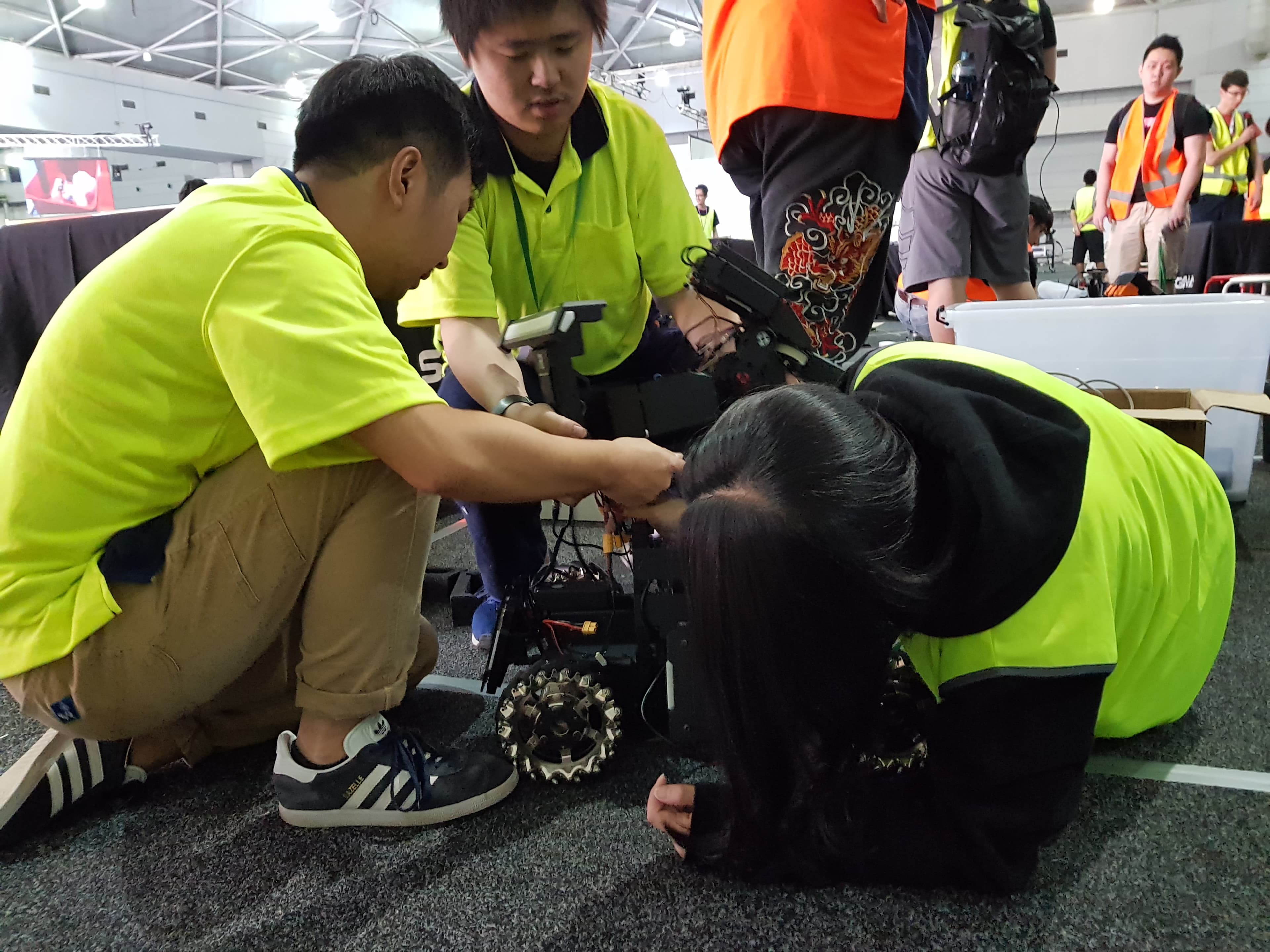 Ausdroid team members preparing their robot at ICRA 2018