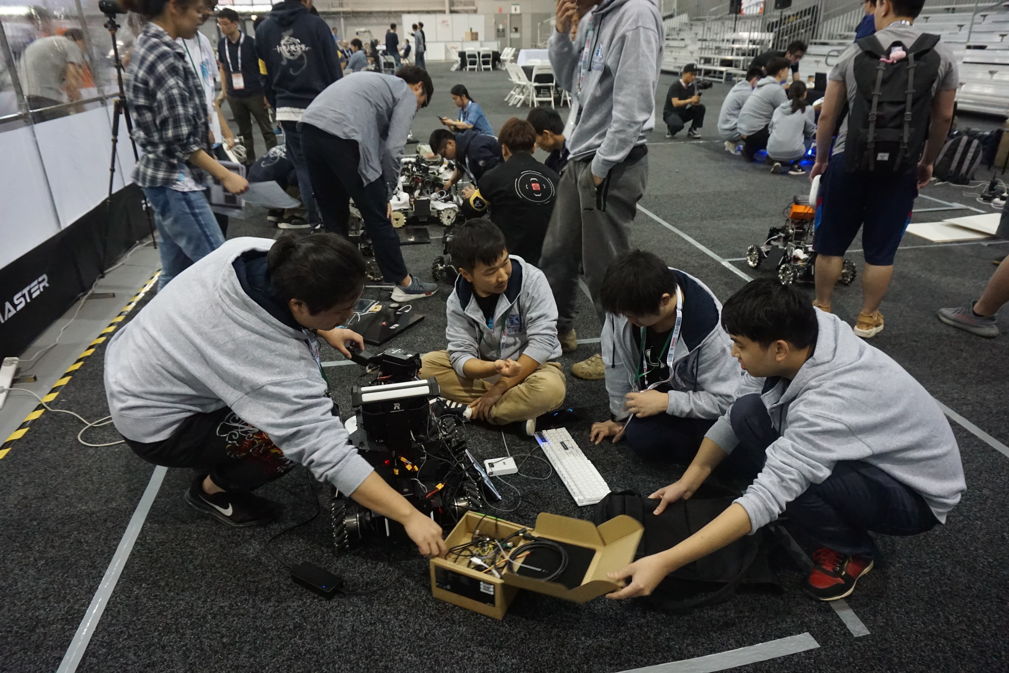 Ausdroid team members checking their robot together