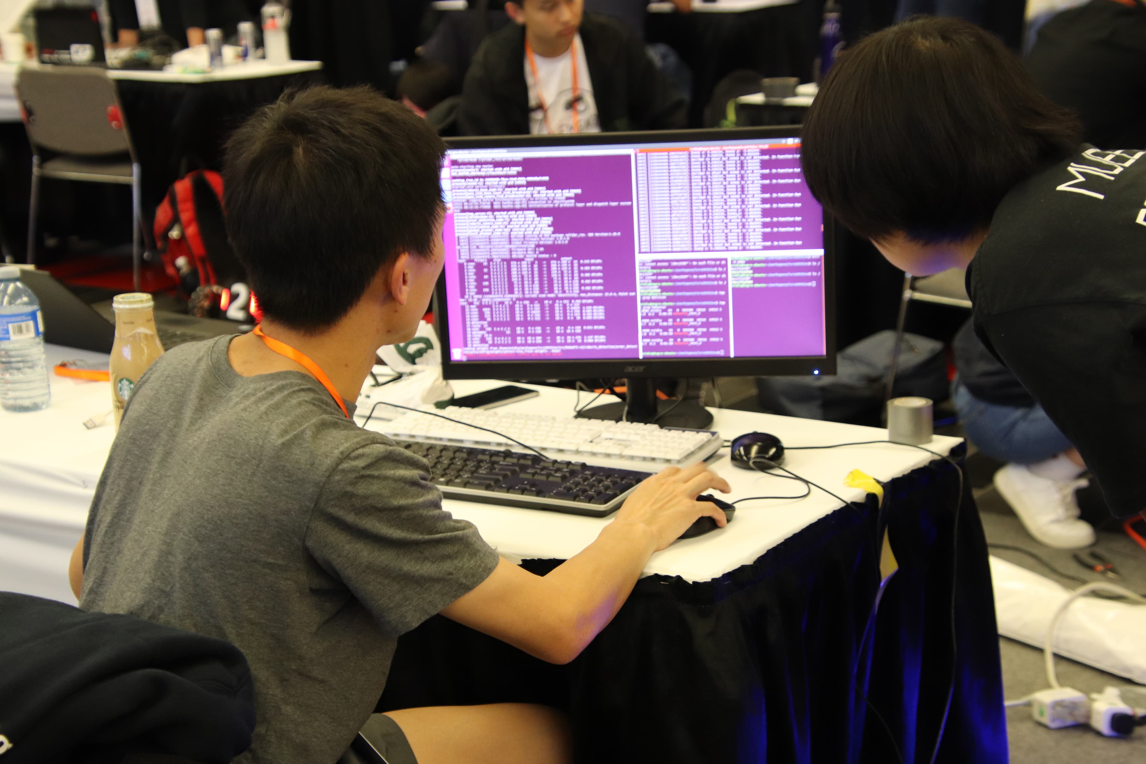 Team members checking robot software on a monitor