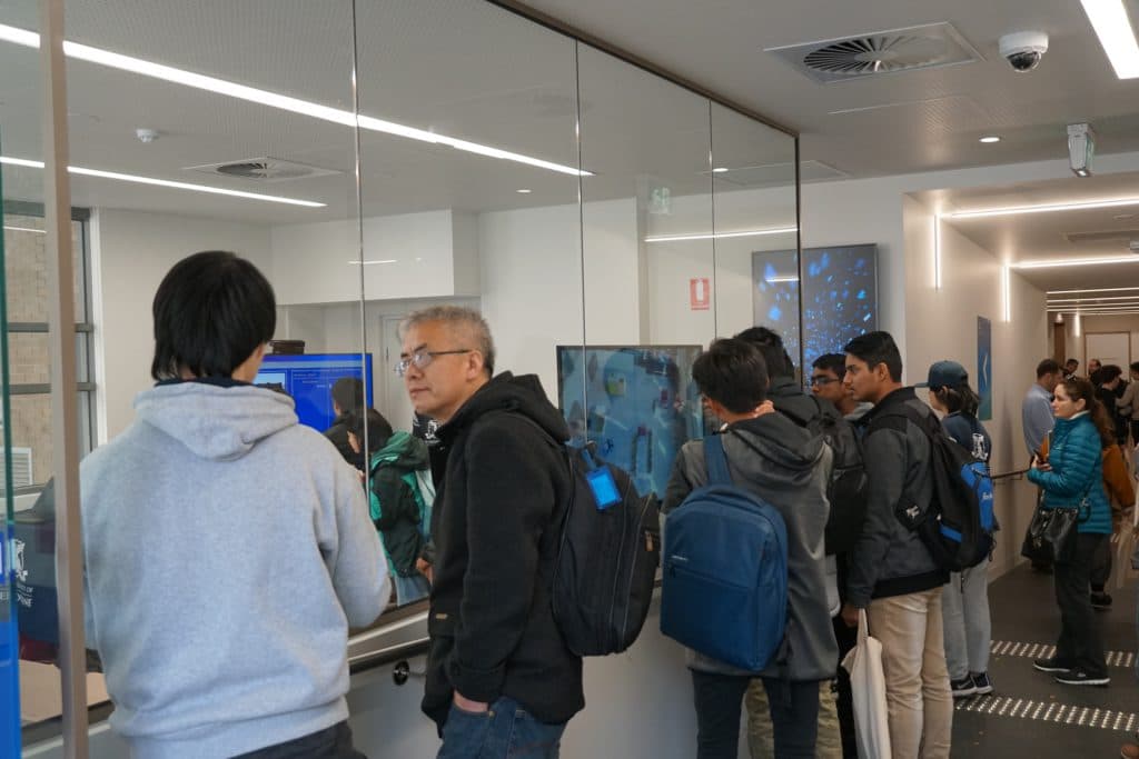 Open Day visitors watching the Ausdroid display through the glass