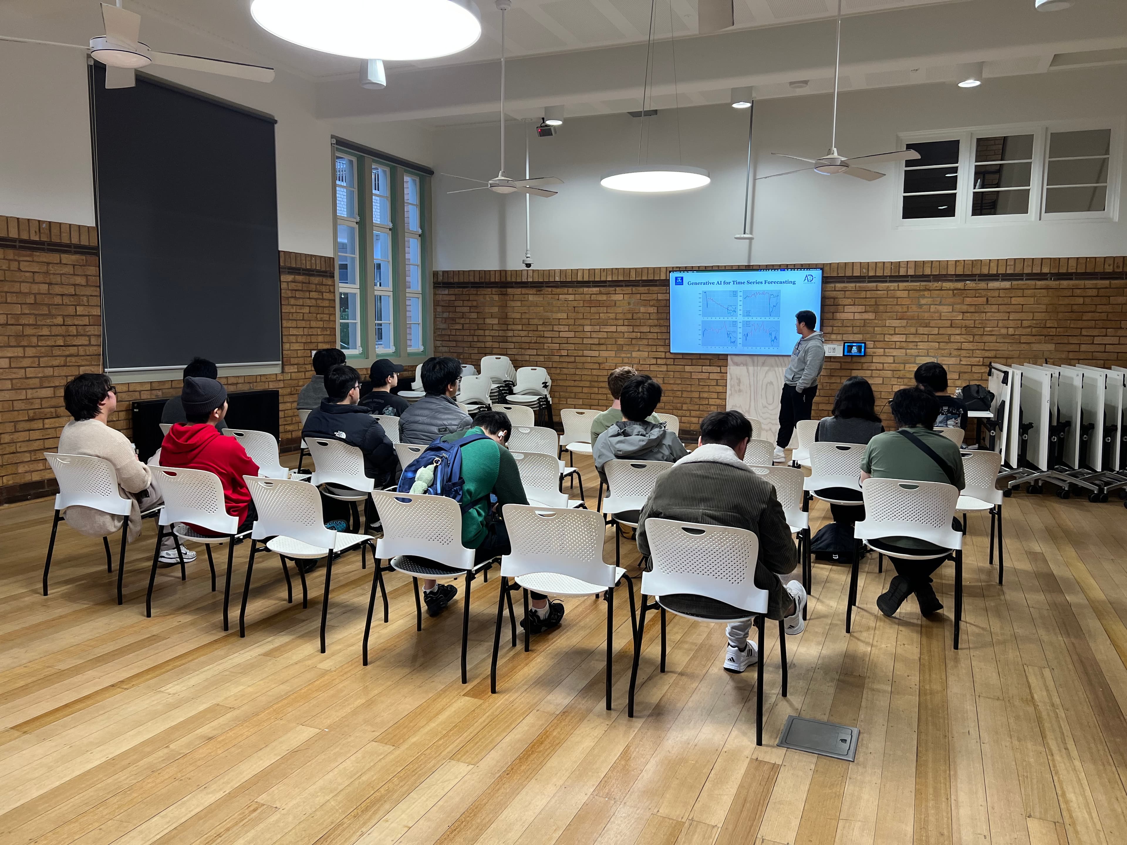 Audience listening to a research project introduction at the University of Melbourne